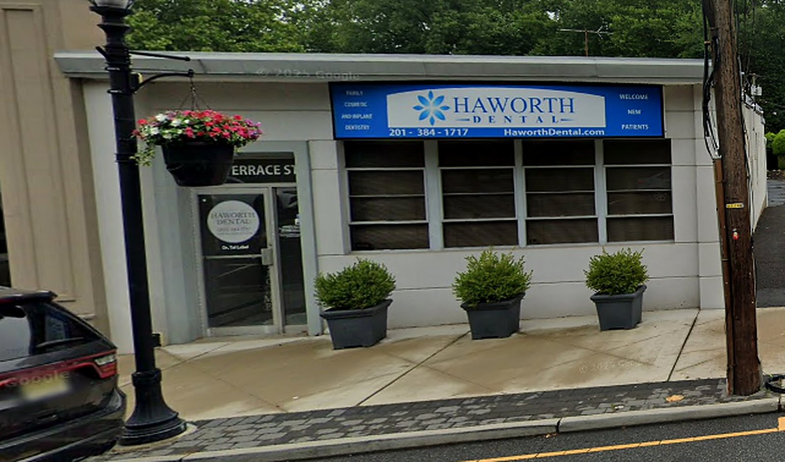 The Haworth Dental office at 141 Terrace Street, with a blue sign above the entrance and planters out front